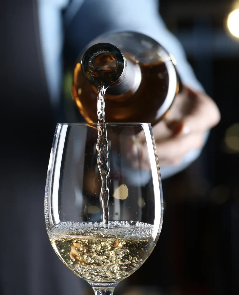 Wine being poured into a glass.